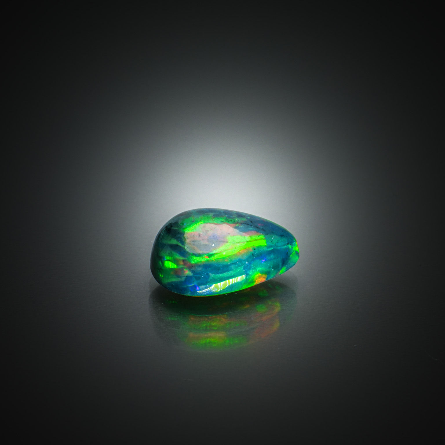 Opale noire poire cabochon sur papier. - Lazuli