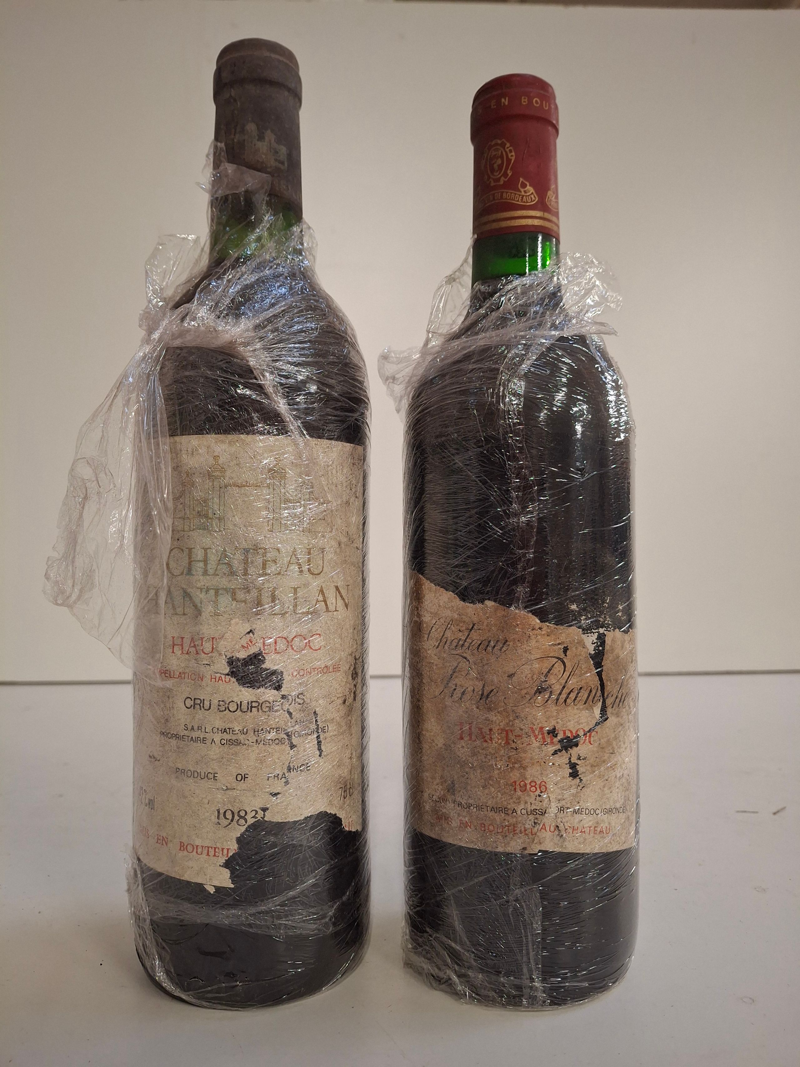 Lot de 2 bouteilles : 1 Château Hanteillan1983 Haut Médoc Cru Bourgeois niveau bon, étiquette abîmée - Lazuli