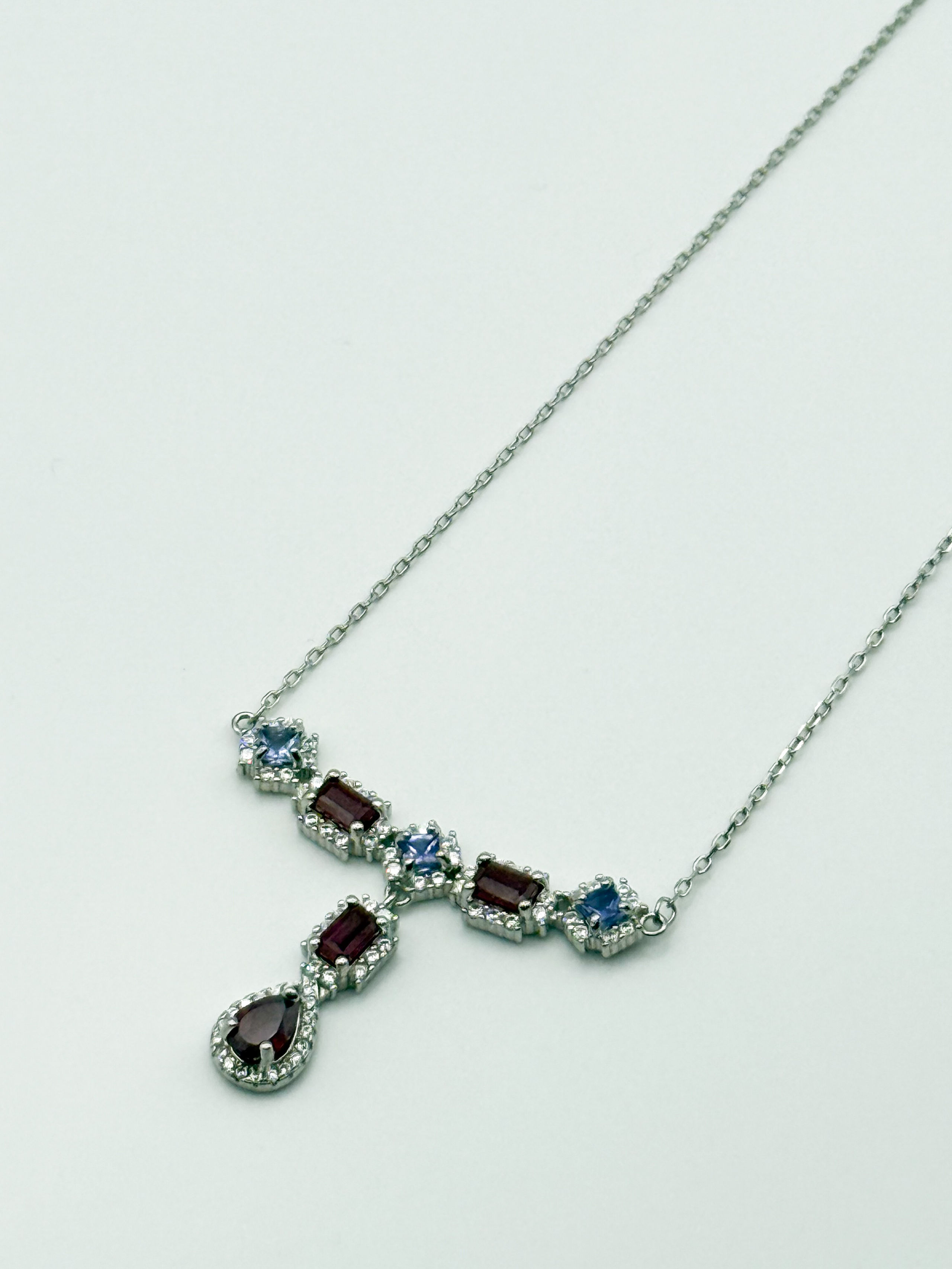 Collier en argent (925 millième) formé d&rsquo;une chaîne à maille forçat et orné de rubis rectangulaires et poire (traités), de tanzanites carrées et de pierres blanches rondes. - Lazuli