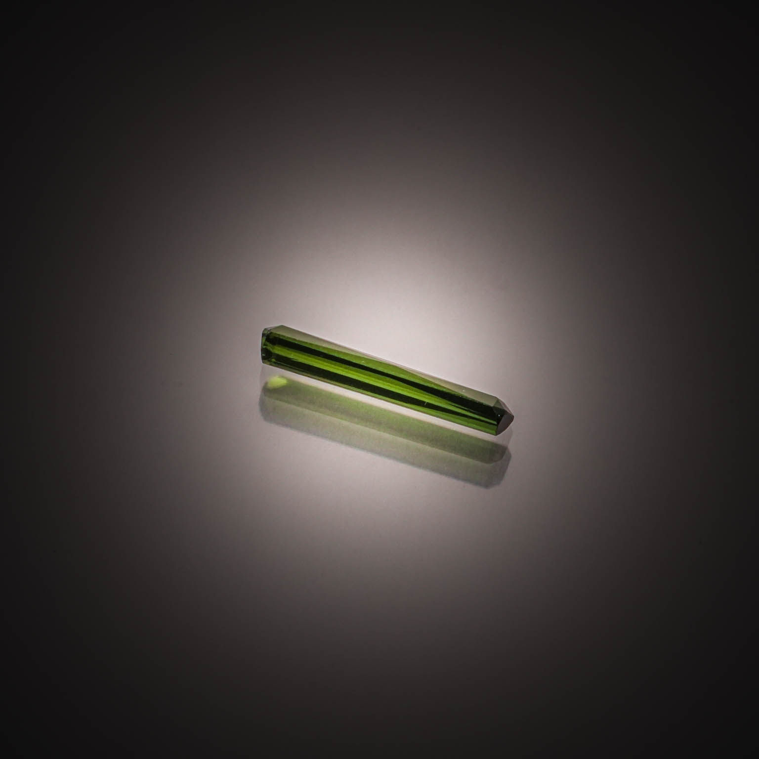 Tourmaline verte octogonale sur papier. - Lazuli