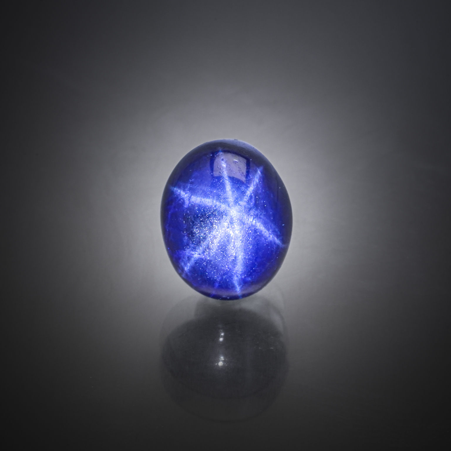 Saphir étoilé ovale cabochon sur papier. - Lazuli