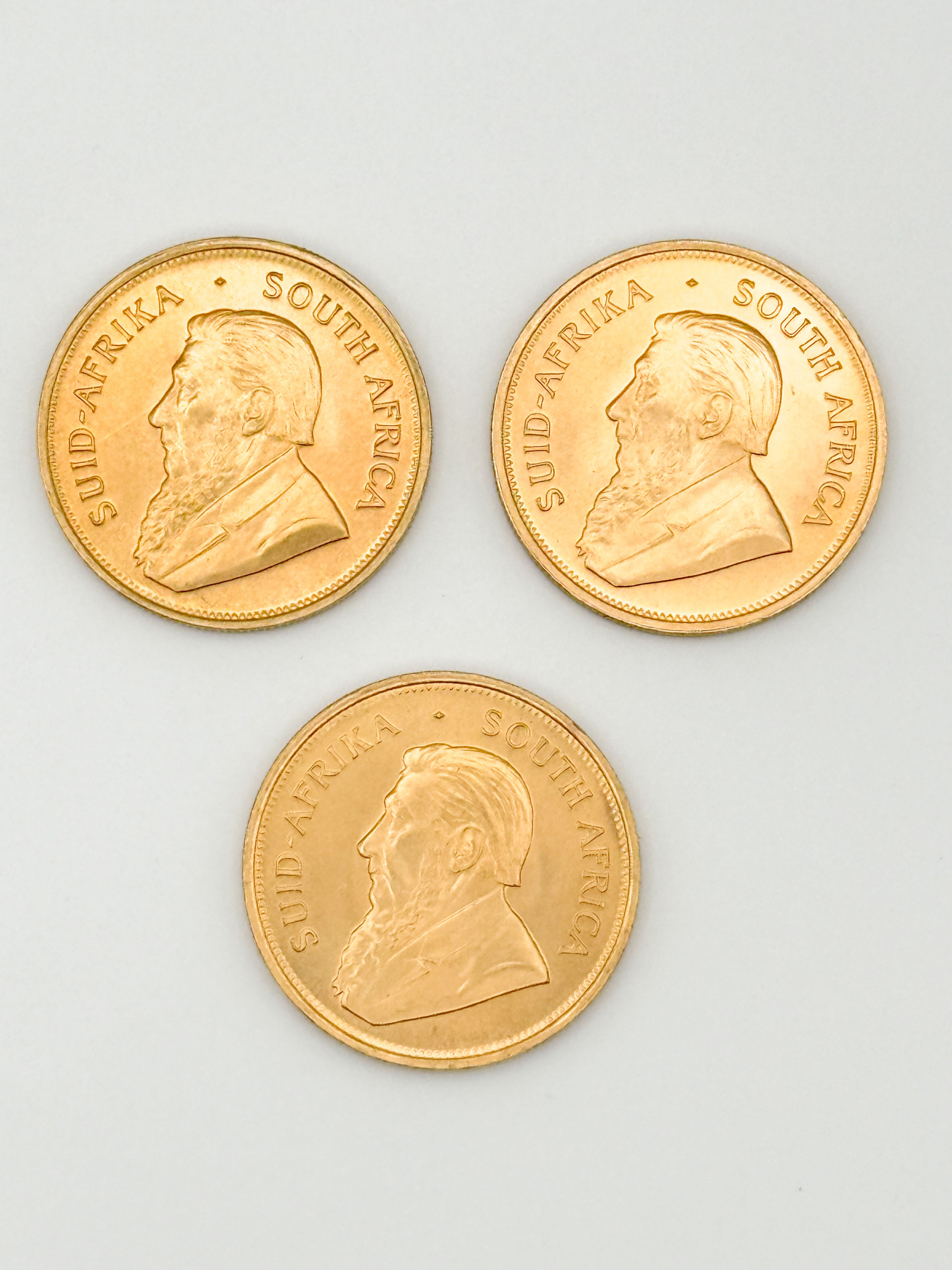 Lot de trois pièces en or de 1 oz kruggerand (1974 x 3). - Lazuli