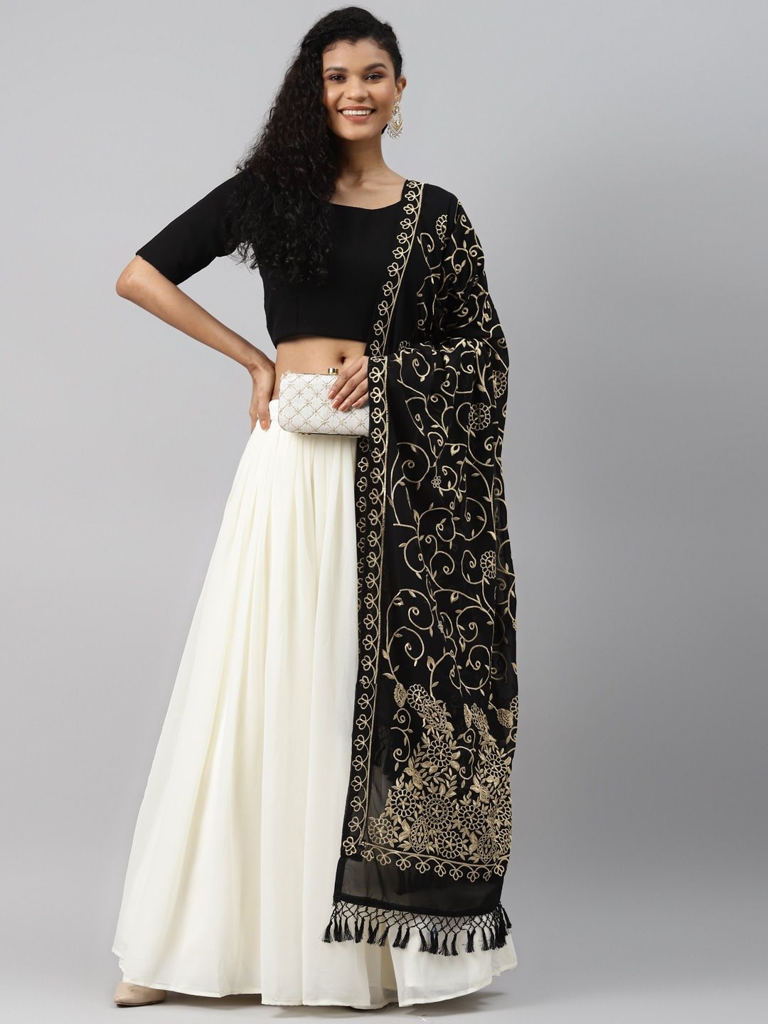 Photo of Black and white lehenga with chain waist belt