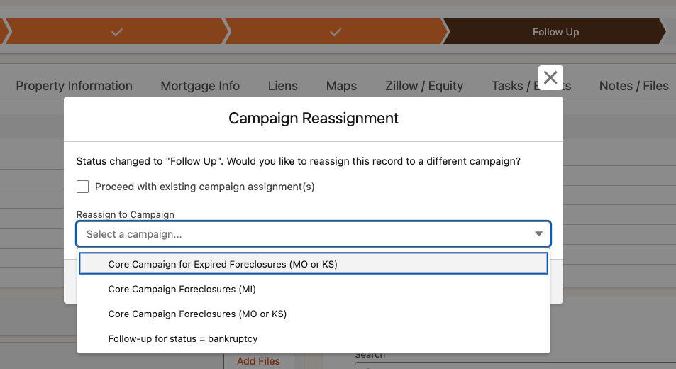 Campaign Reassignment popup shown after a status bar change with a dropdown of available campaigns
