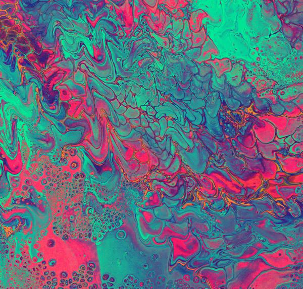 Acrylic pour where spring green and hot crimson collide across the frame, splitting into fine feathered cells at the fault line