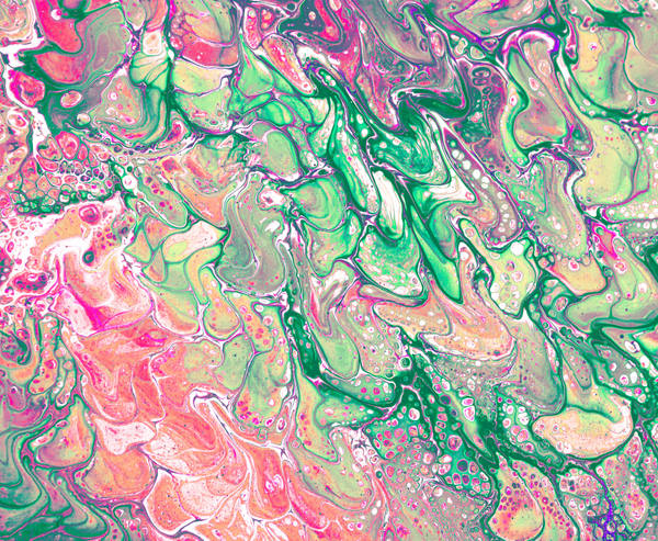 Acrylic pour of rose pink and emerald green tangling over cream in tight looping ribbons