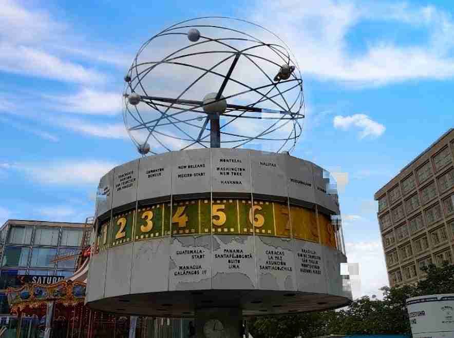 At the world clock of Alexanderplatz, time stops and accelerates, mixes and separates, joins and div…