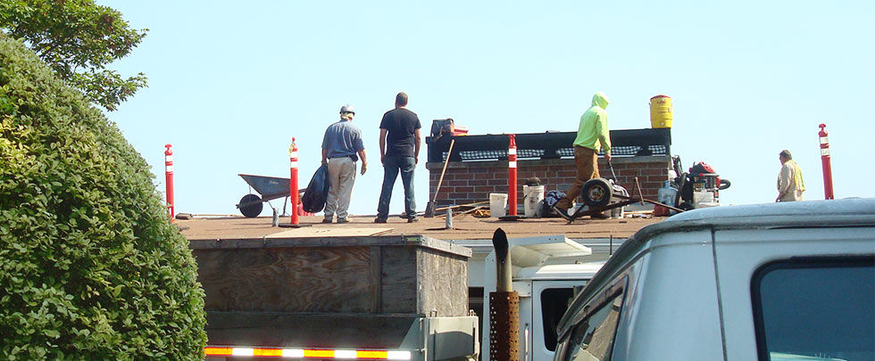 Workers building a foundation with rebar at a construction site.