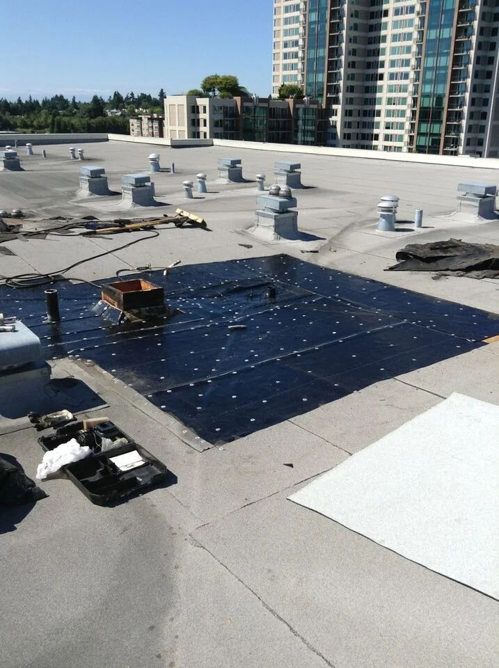 Solar technician installing photovoltaic panels on a sunny rooftop.