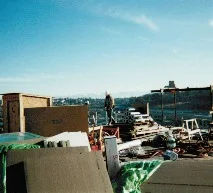 Workers installing solar panels on a rooftop for renewable energy generation.