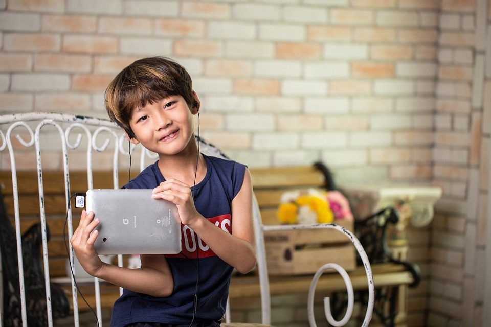 Korean boy playing on his iPad