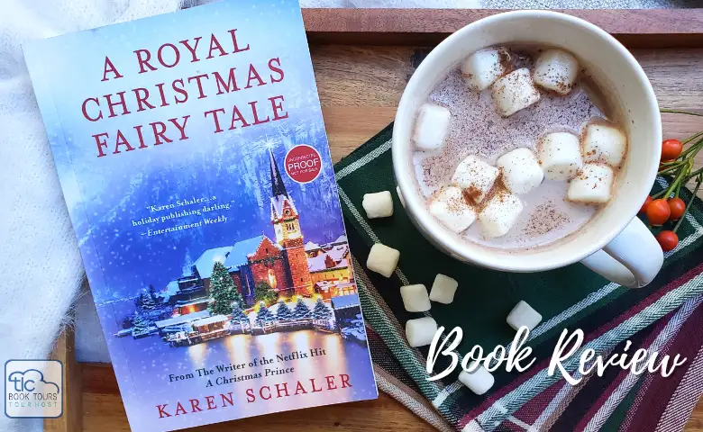 The novel A Royal Christmas Fairy Tale by Karen Schaler on a wooden tray with a cup of hot cocoa with marshmallows.