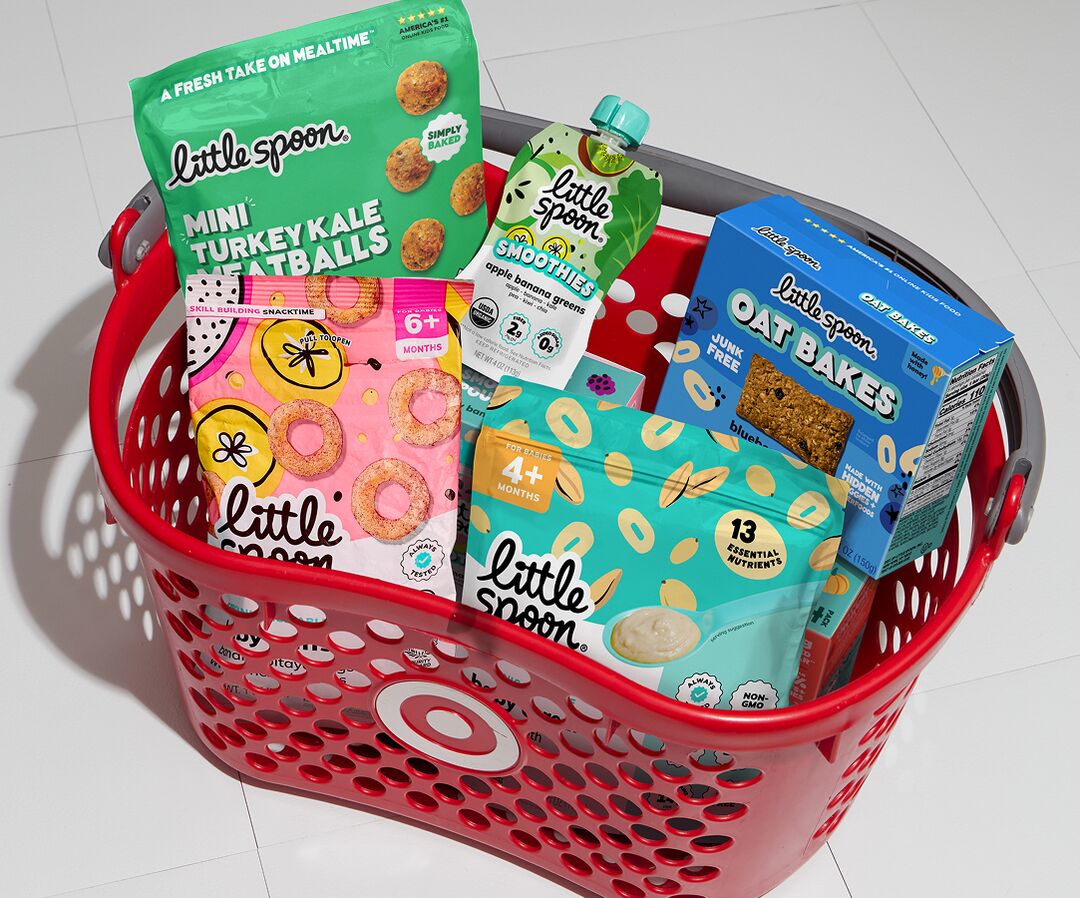 Red Target shopping basket filled with Little Spoon products