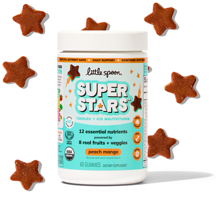 A jar of Little Spoon Super Stars toddler and kid multivitamin gummies surrounded by star-shaped gummies