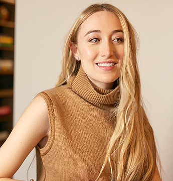 Picture of Ali Bandier smiling mid-speech.