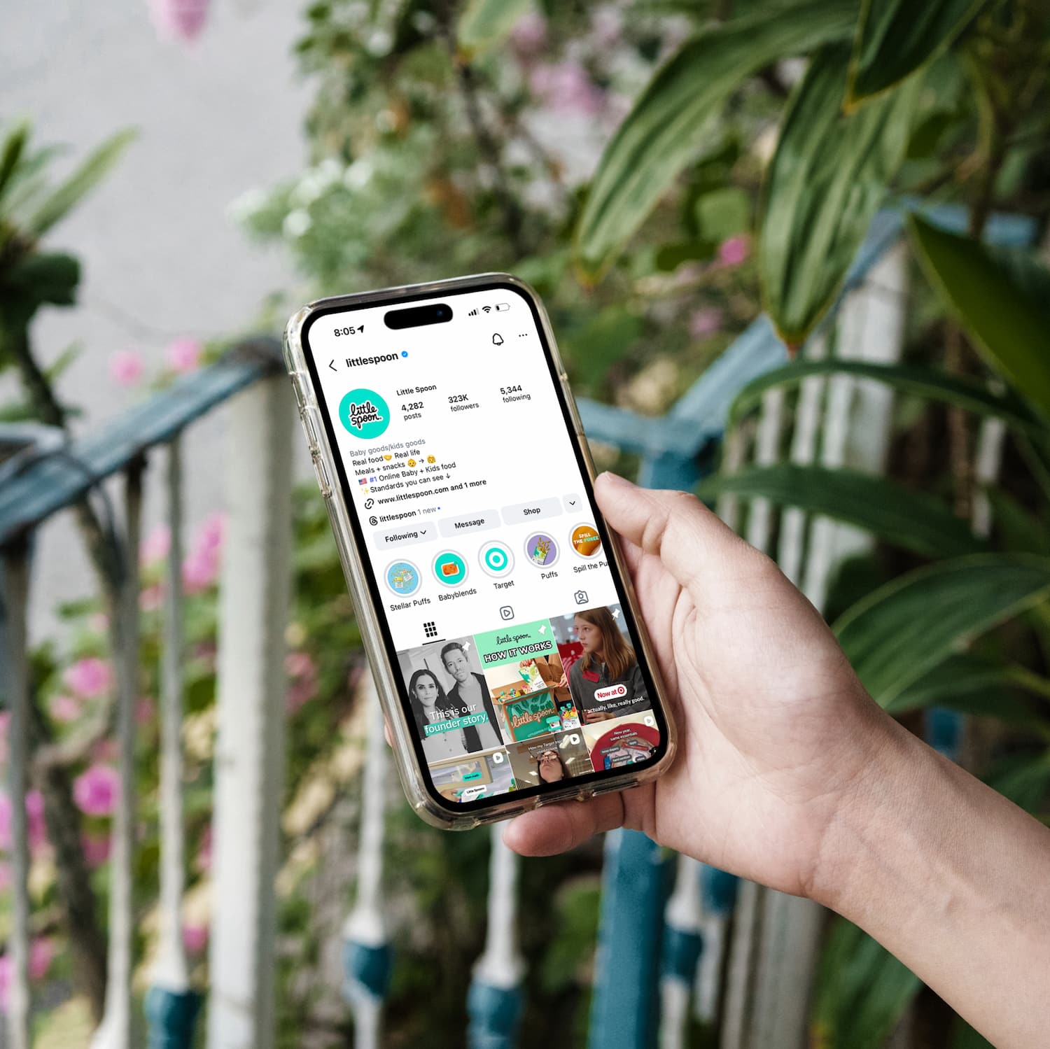 Photo of iPhone in hand with Little Spoon Instagram profile open on screen.