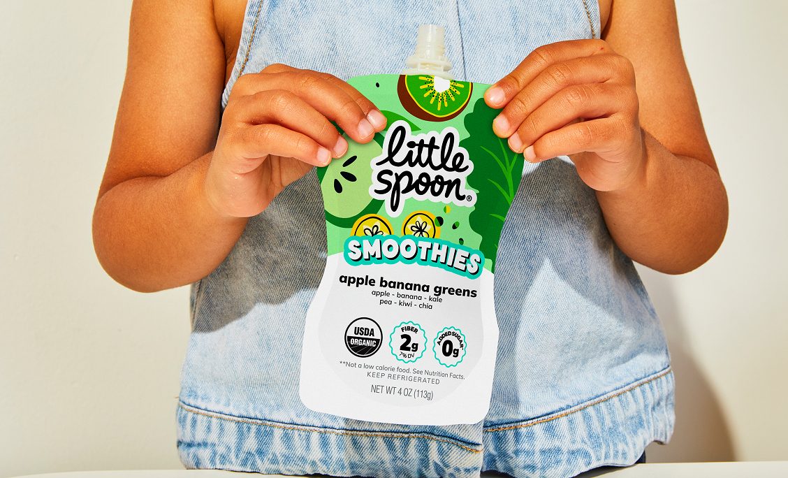 Child holding a Little Spoon Smoothies pouch
