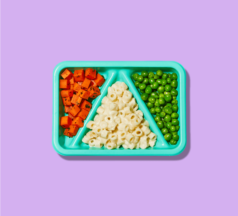 Baby fingers hovering over a tray of diced food suitable for early eaters and proper oral development.