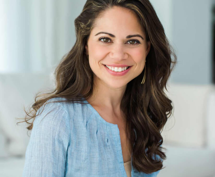 Stephanie Middleberg, Registered Dietician, MS, RD, CDN, and Best-Selling Author, smiling brightly in a light blue top with long wavy hair, set in a soft, light-filled background.