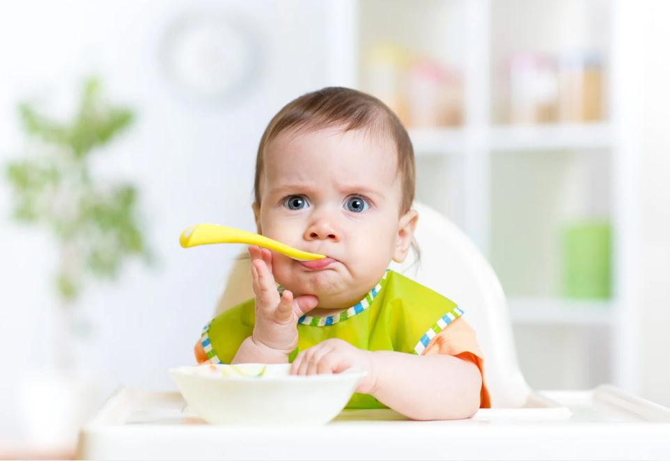 Thinking baby with a spoon.