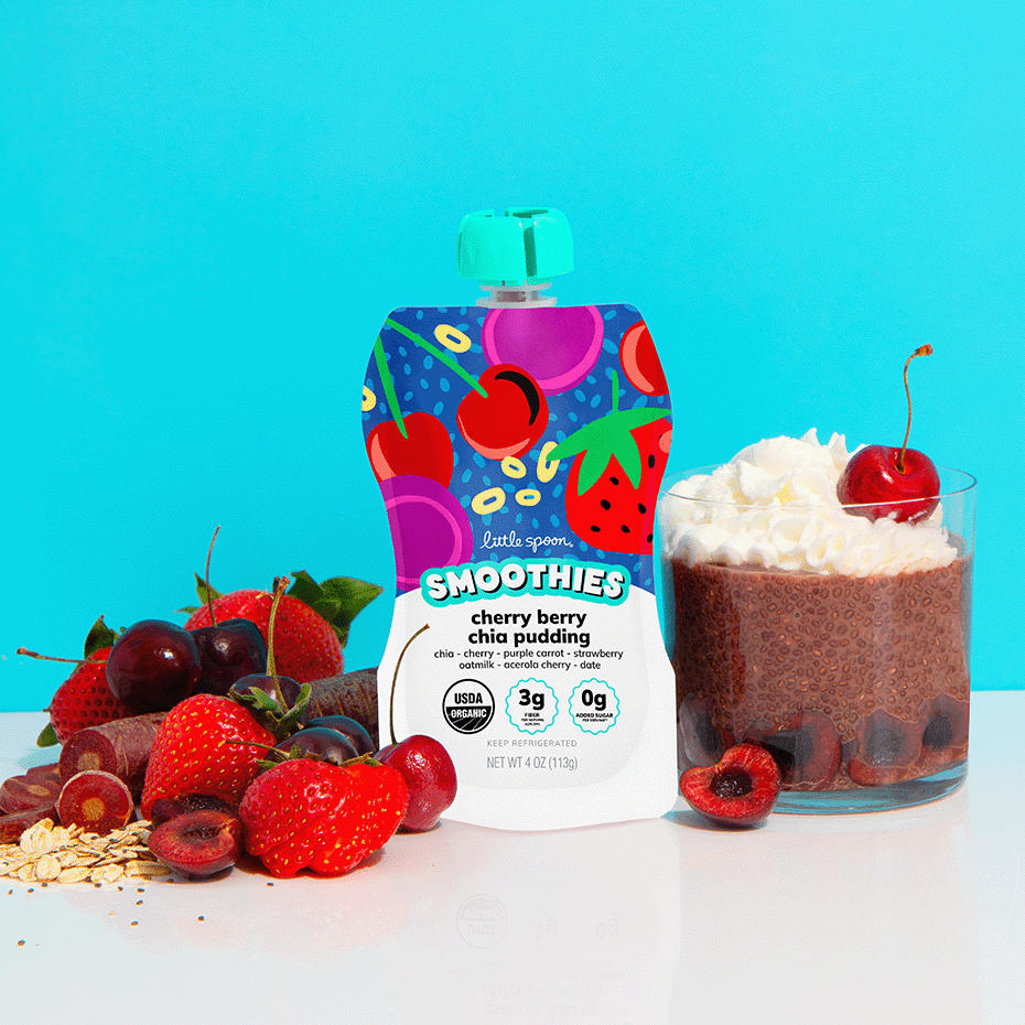 Cherry berry chia pudding smoothie next to cherry chia pudding with whipped cream and berries on a table