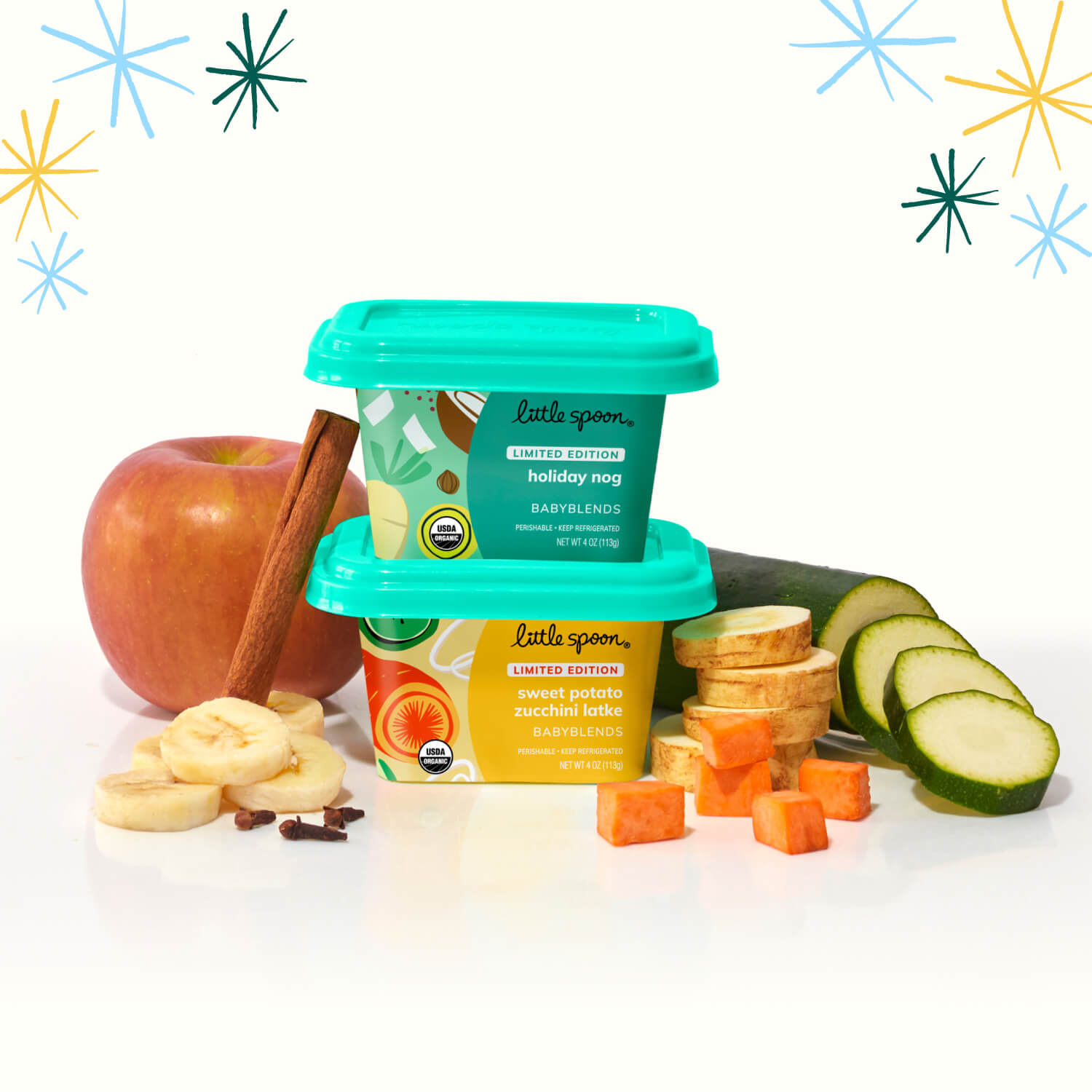 Stacked Limited Edition Sweet Potato Zucchini Latke & Holiday Nog Babyblends surrounded by key ingredients and snowflakes