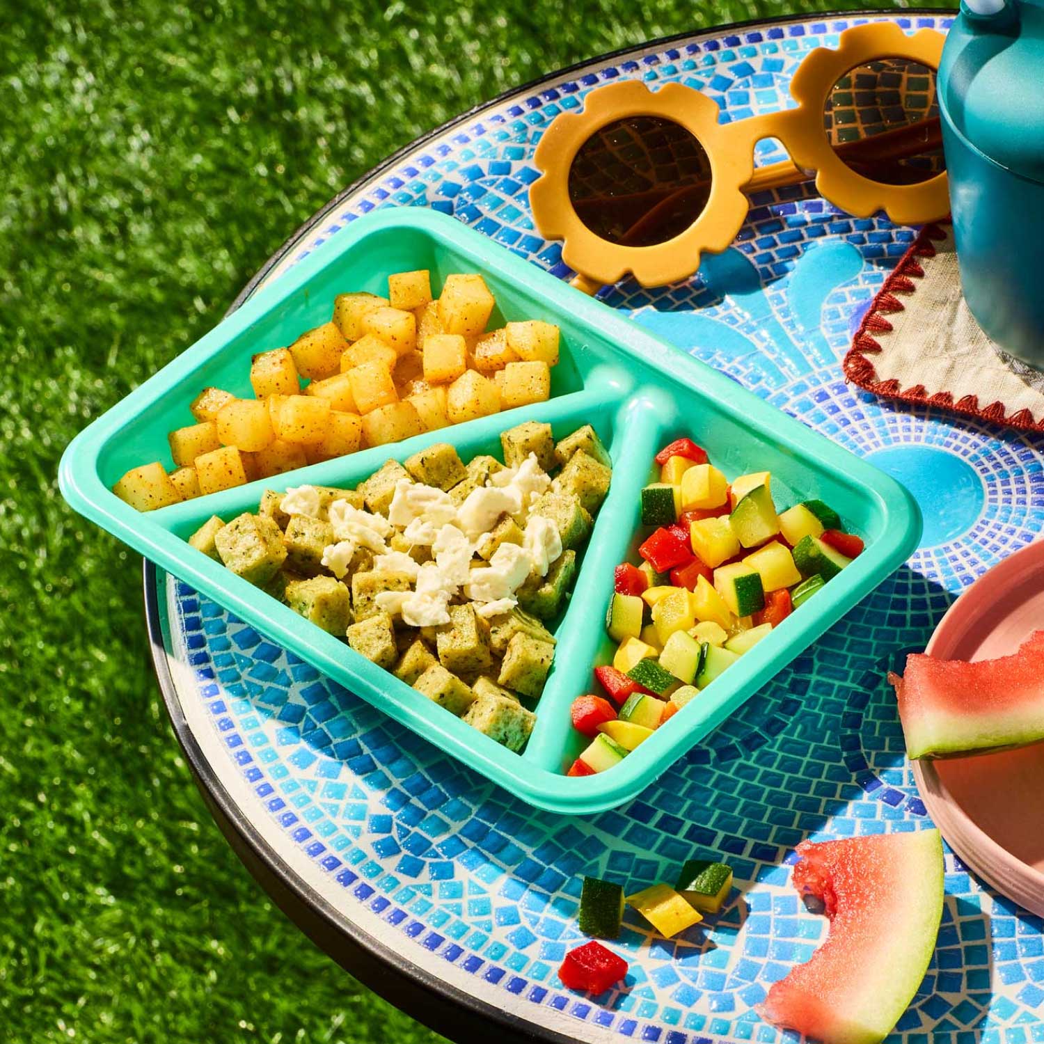 Chicken Gyro Bites Biteable on a tray with flower sunglasses, watermelon slides