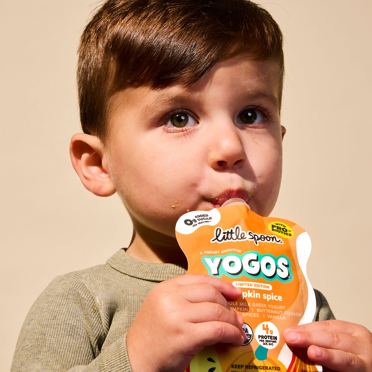 Child drinking Limited Edition Pumpkin Spice YoGo pouch