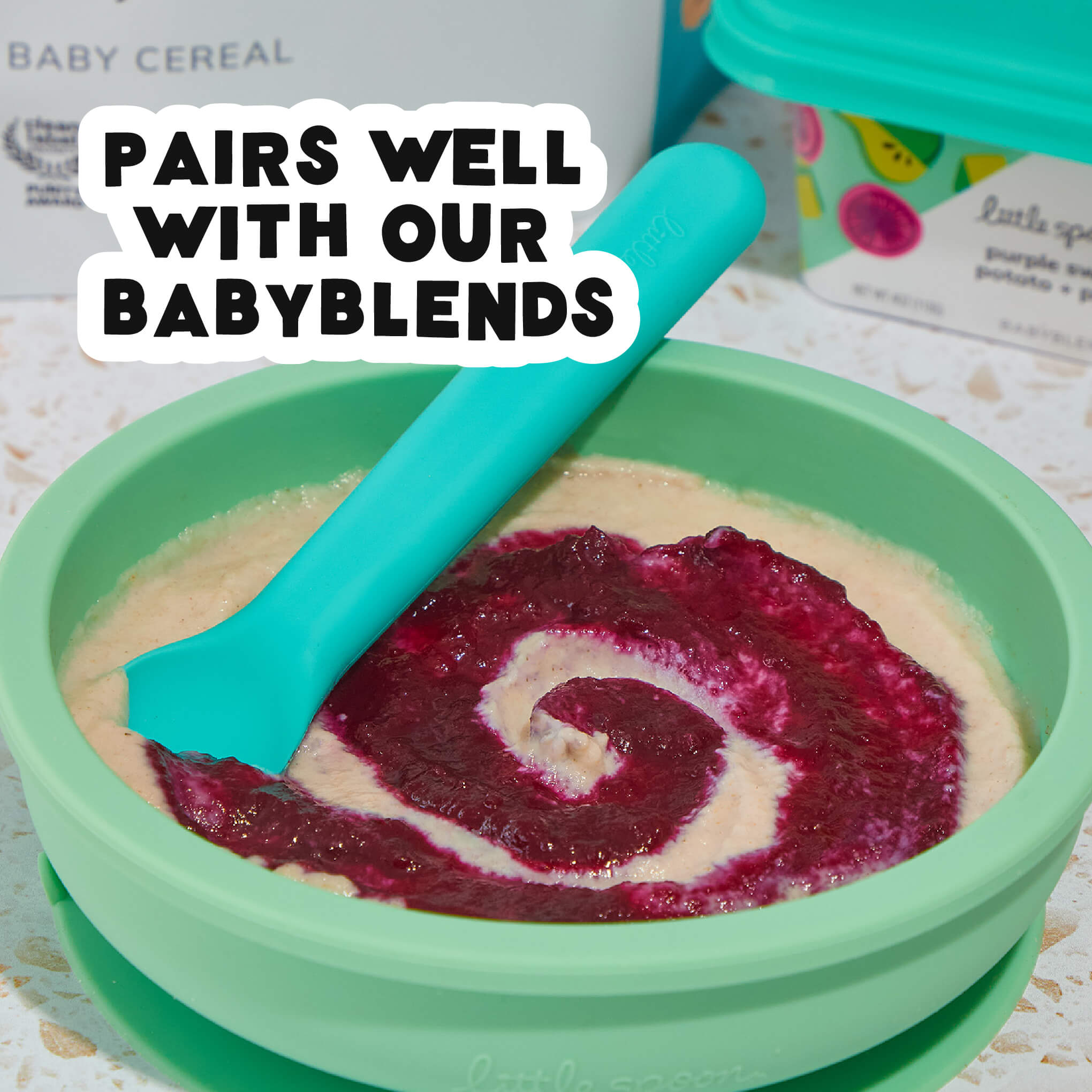 Oatmeal Baby Cereal mixed with blends puree in a mint bowl with a teal spoon pairs well with our Babyblends