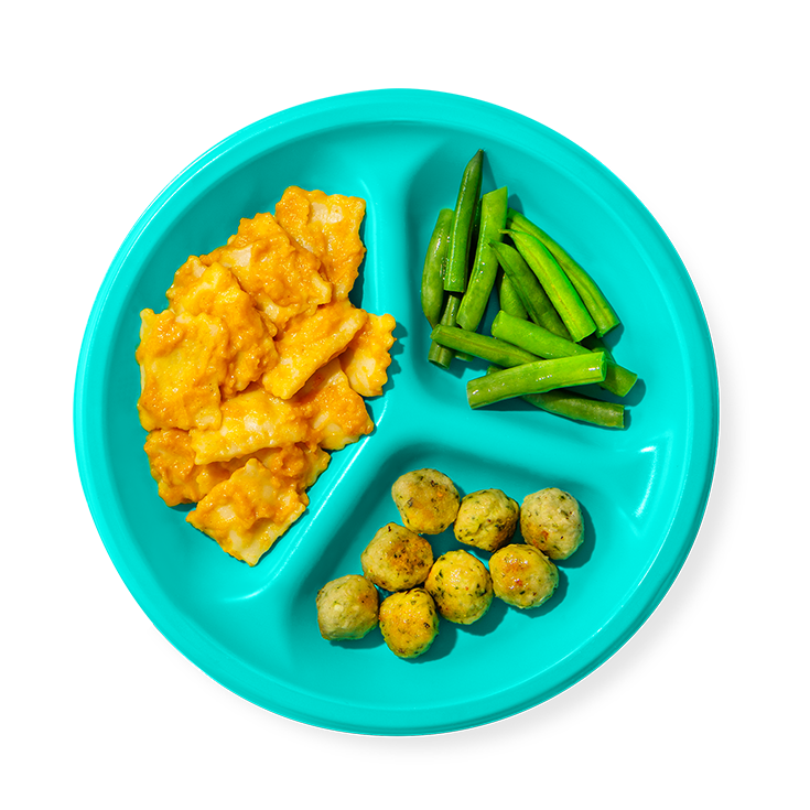 Image of butternut squash ravioli with creamy pumpkin sauce + green beans + mini turkey kale meatballs plate