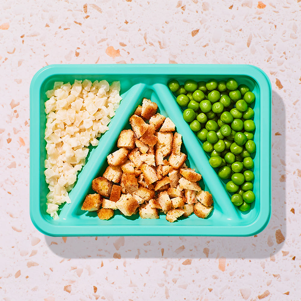Breaded chicken and vegetable bites and cheesy riced cauliflower and peas Biteable