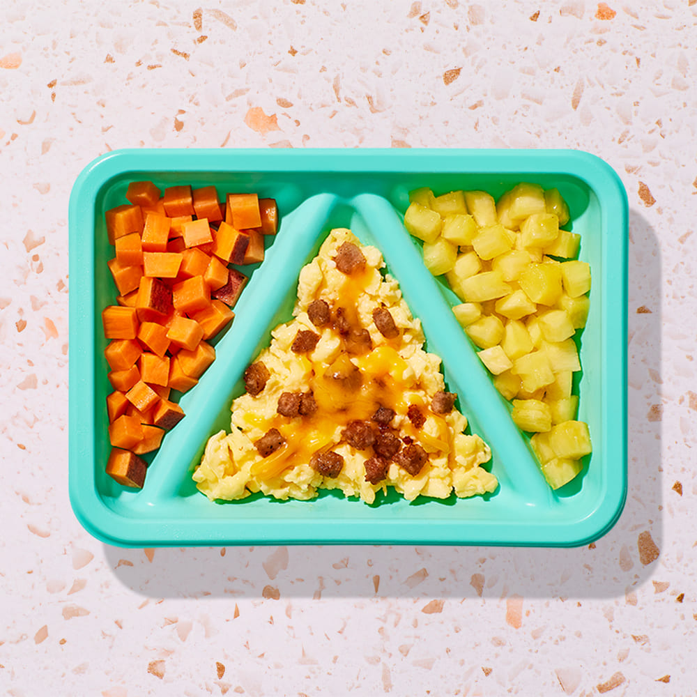 Cheesy cage-free scrambled eggs and crumbled sausage and sweet potatoes and pineapple Biteable meal