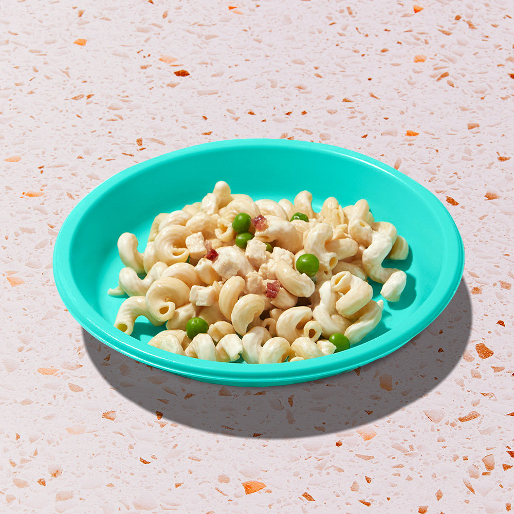 Creamy Chicken Cavatappi Plate with white meat chicken, peas + bacon in alfredo-style sauce