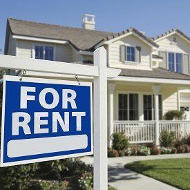 Home with for rent sign in front yard