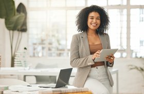 A Happy Business Person with a tablet in hand