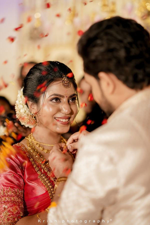Bride and groom celebrating amid a shower of petals
