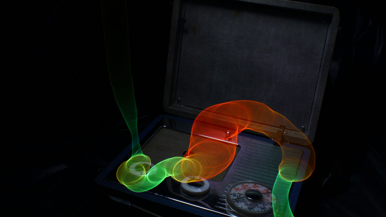 a photograph of a radio with glowing light above it