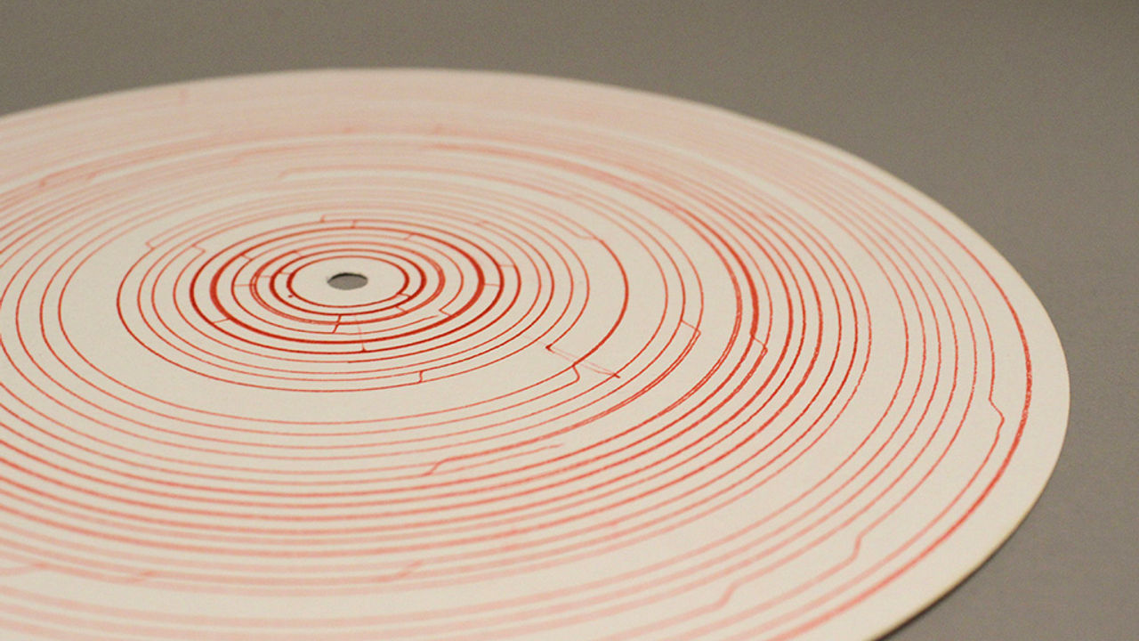 close up photo of a circular disc with erd line drawings on