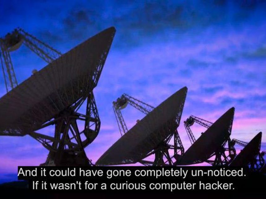A video still showing a field of large satellite dishes with a blue/pink sky in the background