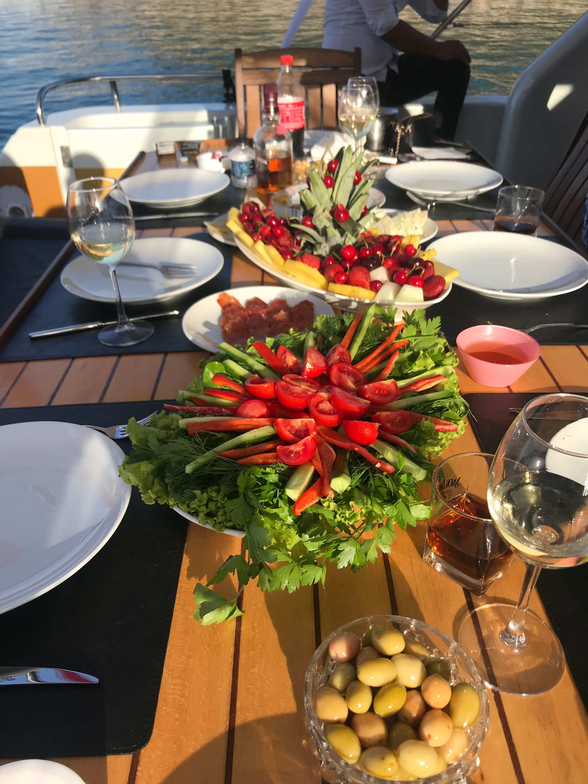 Table with fresh vegetables, olives, and drinks on a yacht during Regnum Yacht Tour Antalya Private Charter Experience