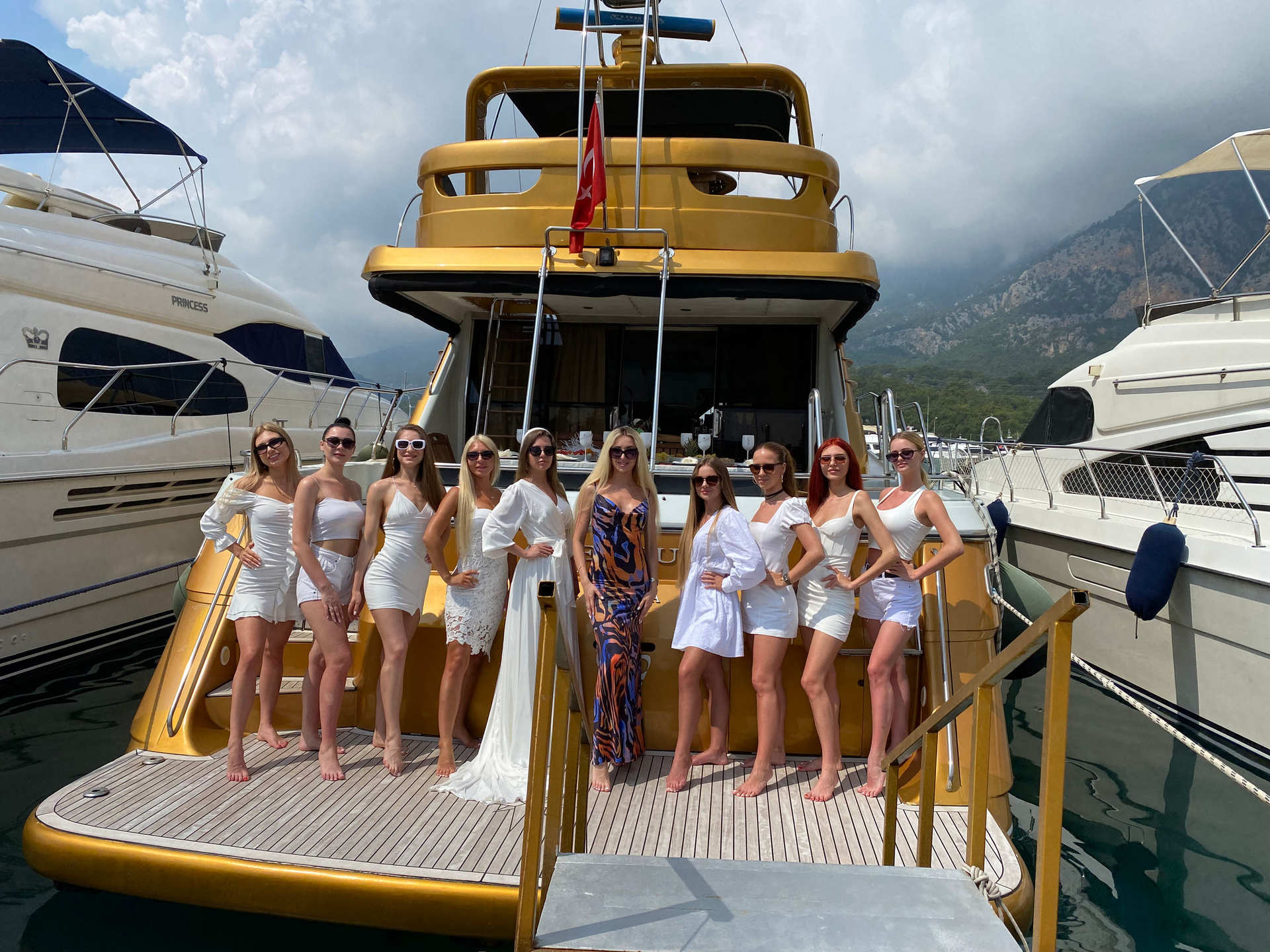 Group of women standing on the deck of the Regnum Yacht Tour Antalya Private Charter Experience yacht