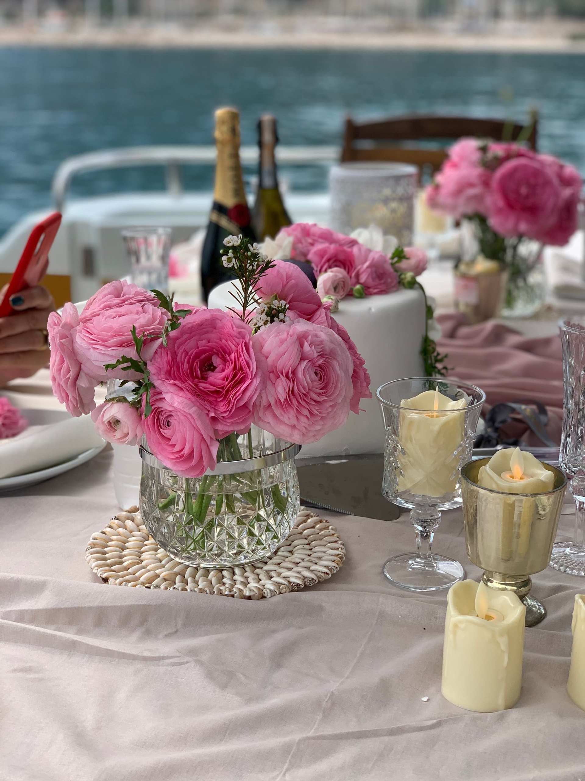 Table setting with pink flowers and candles on Regnum Yacht Tour Antalya Private Charter Experience