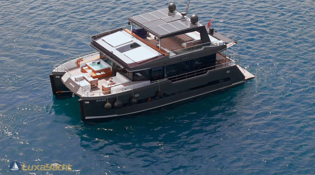 Brise Yacht catamaran floating on calm blue water with visible deck and upper structure