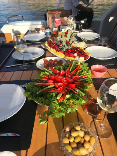 Enjoy a fresh and colorful dining setup on the Regnum Yacht Tour Antalya Private Charter Experience