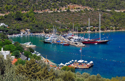 Yachts docked at Torba Marina with clear blue water and surrounding green hills