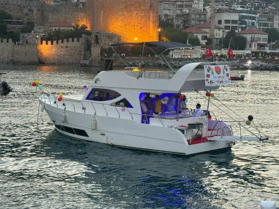 Elifim yacht decorated with balloons and a birthday sign on the water