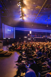 Attendees before a scene at a conference