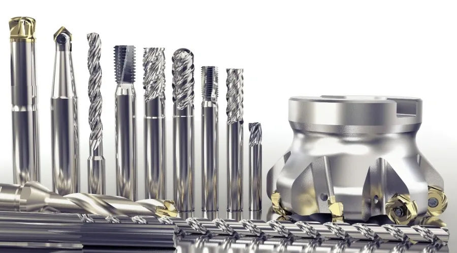 Various types of shiny CNC cutting tools and a milling cutter displayed on a reflective surface.
