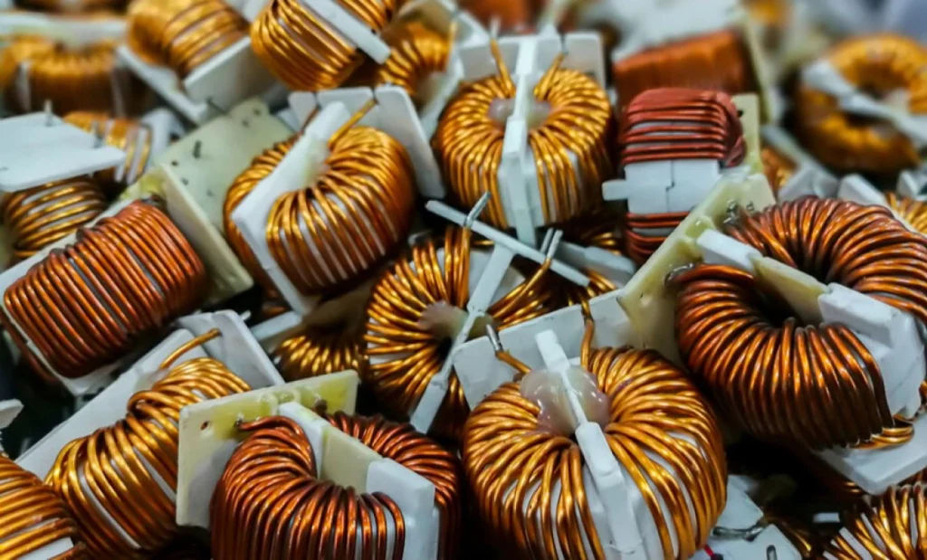 Close-up of multiple copper wire coils used in electronic components and circuit designs.