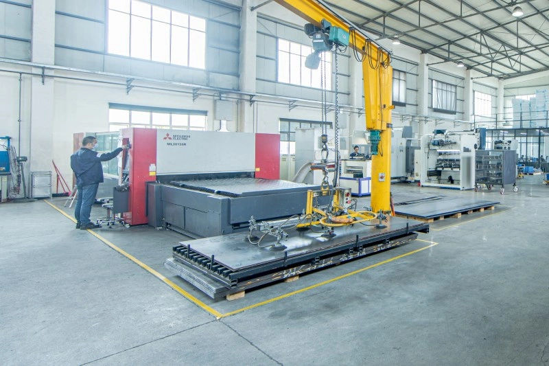 Industrial laser cutting machine in a spacious factory highlighting precision and efficiency in metal fabrication.